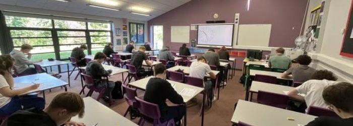 Sidmouth sixth formers sitting at desks taking the ukmt maths challenge